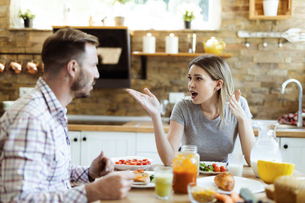 istock Angry young  couple arguing during breakfast at home 1415228737