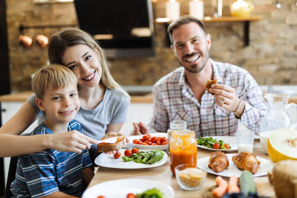 istock Happy family  talking during lunch time at dining table 1415228758