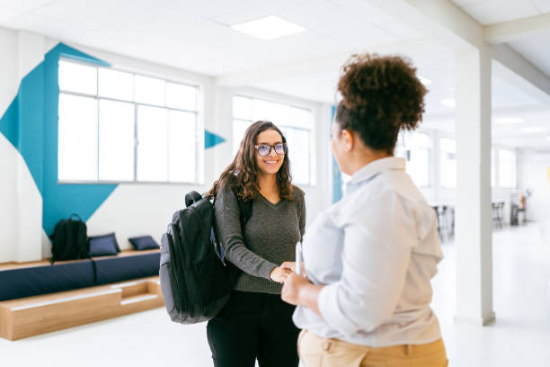 istock Manager woman greeting a coworker 1415229043
