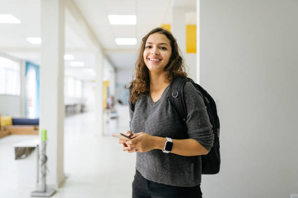 Portrait of a smiling college student Portrait of a smiling college student female likeness stock pictures, royalty-free photos & images