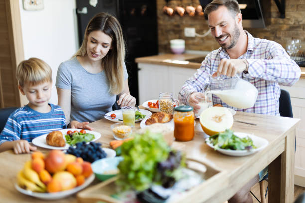 istock Happy family  talking during breakfast  time at dining table 1415229801