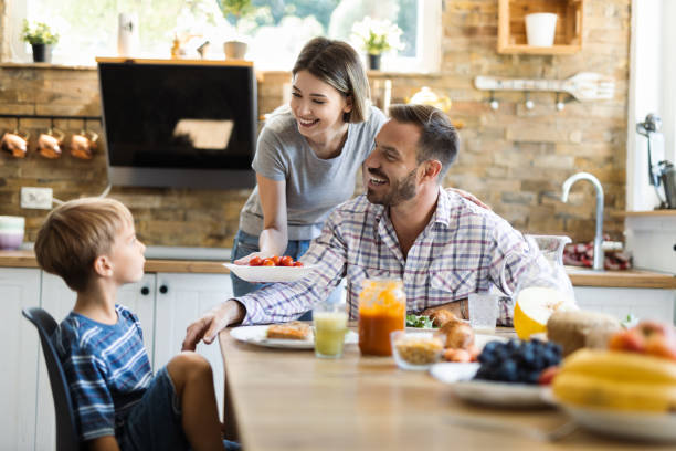 istock Happy family having fun while enjoying in lunch time 1415230181