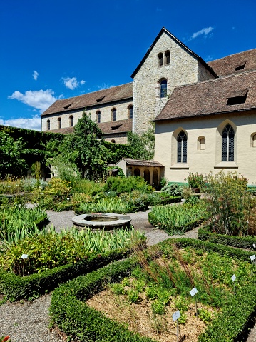 The Kloster Allerheiligen (All Saints abbey) is a former Benedictine monastery in the Swiss municipality of Schaffhausen. The image shows the minster church and the surrounding herbal garden captured during summer season,