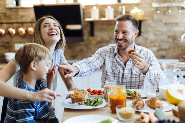 istock Happy family having fun during breakfast time  in the kitchen 1415230442