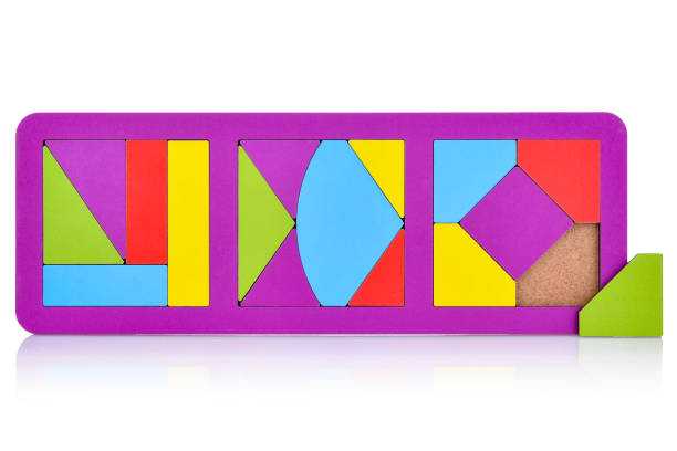 istock Wooden multi-colored puzzles for children, isolated on a white background. Bright geometric-shaped puzzles. Montessori, children's educational games. Development of fine motor skills and logic 1415231193