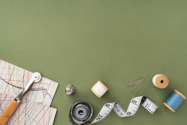 istock Pattern, fabric and sewing accessories on a green paper background, flat, lay, top view, copy space. A tailor or seamstress desk. Sewing concept, background. Tailoring of designer clothes 1415231901