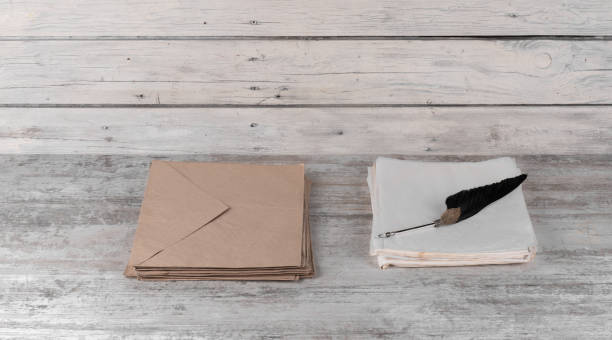 istock pen with a feather and an old brown paper envelope for writing 1415232583