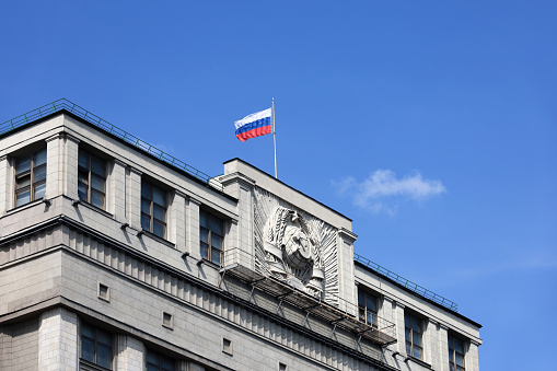 Facade of State Duma of Russia with soviet coat of arms, russian authority