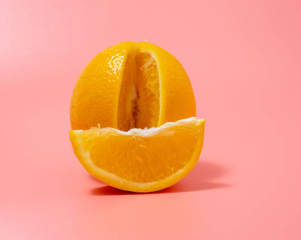 istock Orange and orange slice. Orange on a pink background. 1415233185