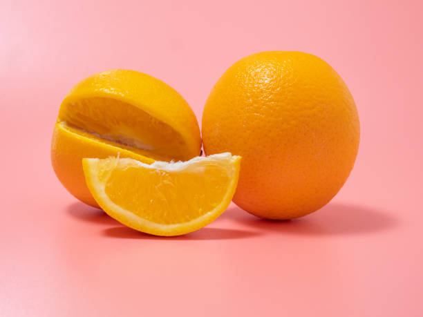 istock Orange and orange slice. Orange on a pink background. 1415233187