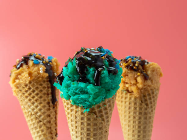 istock Turquoise blue and caramel ice cream on a pink background. 1415233189