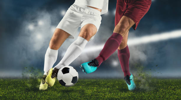 Soccer player stops a striker with a sliding tackle.