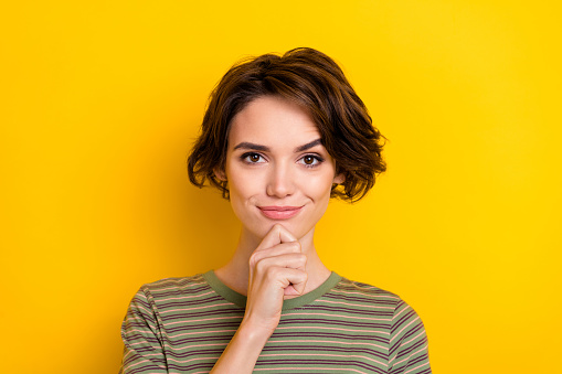 Closeup photo of young girl hold hand chin think smart student looking you isolated on yellow color background
