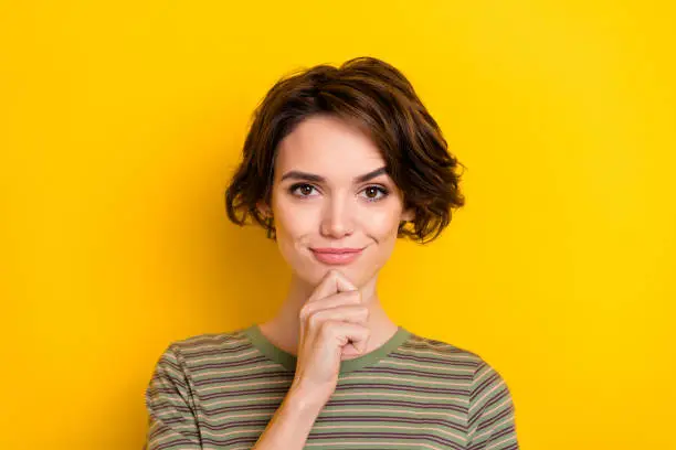 Closeup photo of young girl hold hand chin think smart student looking you isolated on yellow color background.
