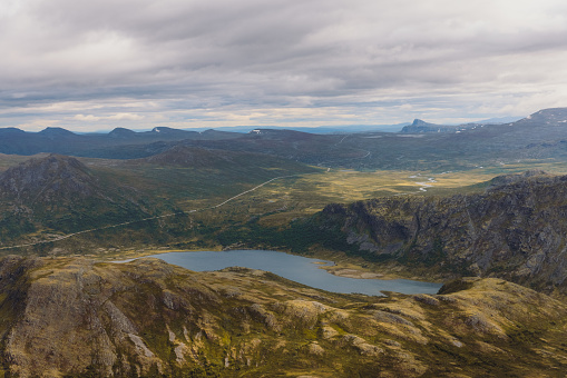 High angle view of the scenic mountain area over Bessegen ridge with high peaks, crystal blue lakes and the glacieers in Innlandet country, Scandinavia