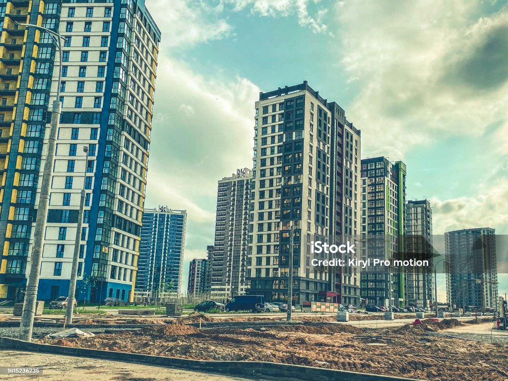 construction of a new residential area in the city center. high-rise block houses are painted in different colors. blue and yellow wall paint construction of a new residential area in the city center. high-rise block houses are painted in different colors. blue and yellow wall paint. Diminishing Perspective Stock Photo