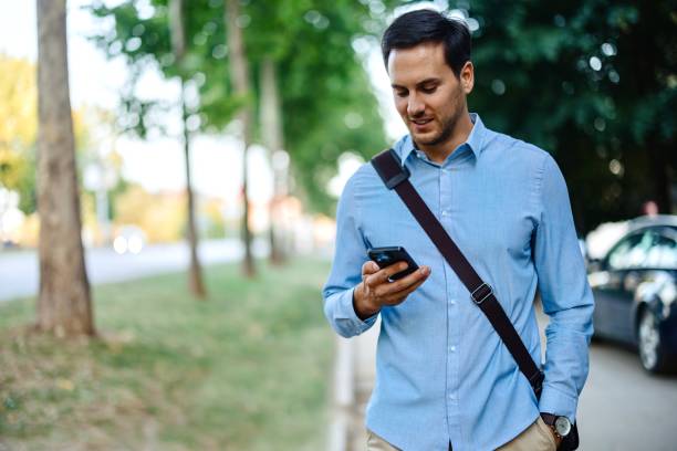 istock Businessman in downtown, using mobile phone 1415237304