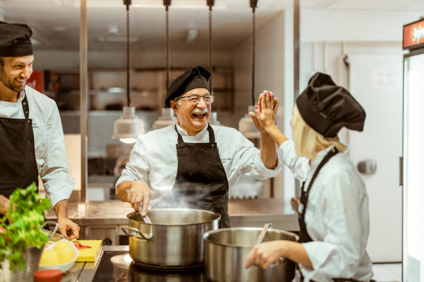 istock Team of cooks giving five with hands 1415237324
