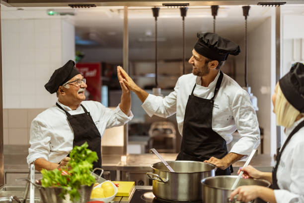 istock Team of cooks giving five with hands 1415237327