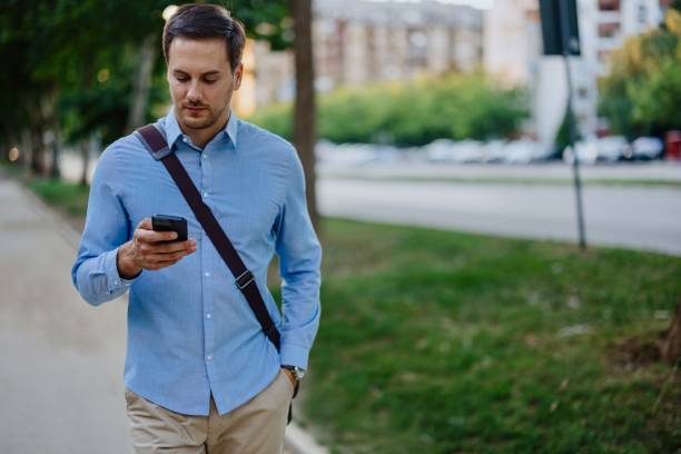 istock Businessman in downtown, using mobile phone 1415237328