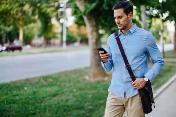 istock Businessman in downtown, using mobile phone 1415237340