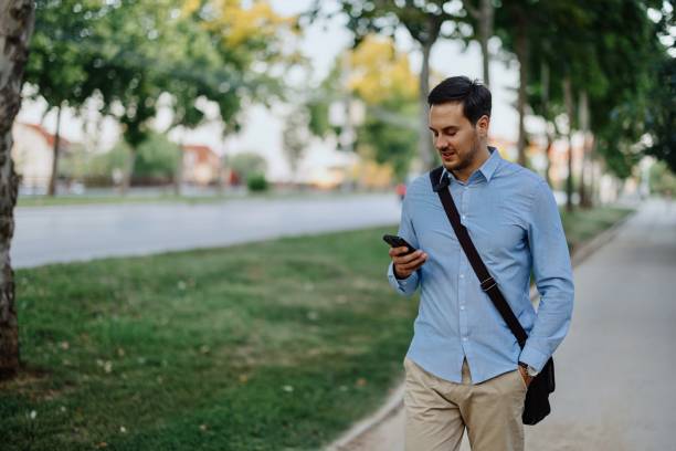 istock Businessman in downtown, using mobile phone 1415237344