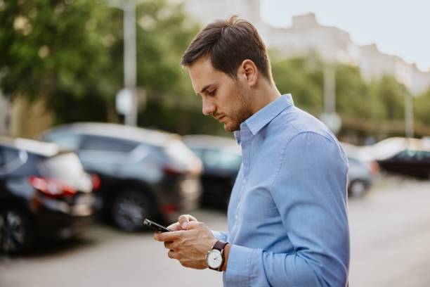 Businessman in downtown, using mobile phone