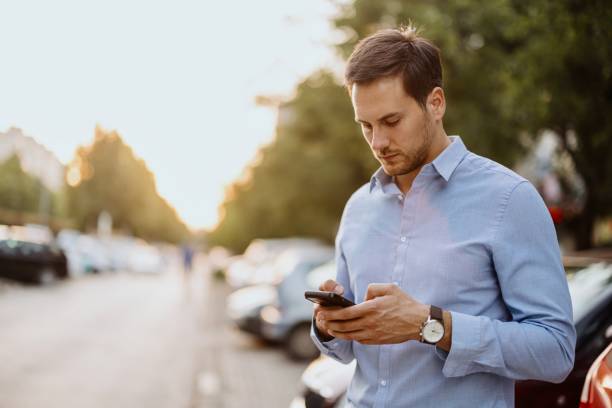 istock Businessman in downtown, using mobile phone 1415237354