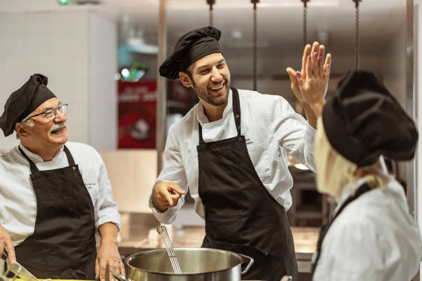 istock Team of cooks giving five with hands 1415237382