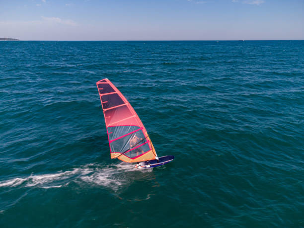 istock skiing windsurfing in the sea at sunset 1415238865