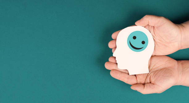 Holding a smiling happy face in the hands, positive emotions, good customer feedback stock photo
