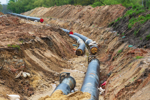 istock Gas pipeline under construction. Black pipes buried in the ground. 1415241486