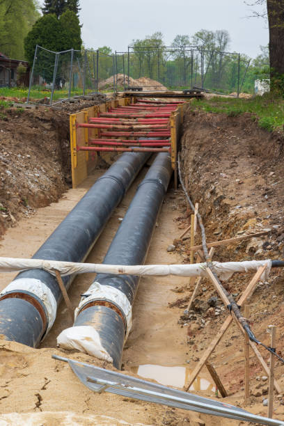 istock Gas pipeline under construction. Black pipes buried in the ground. 1415241501