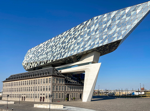 Antwerp, Belgium - August 2022: Exterior of the Antwerp Port Authority building in the city's commercial docks. The architect was Zaha Hadid.