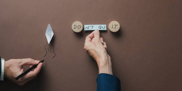 istock Top view of male and female hands assembling a Do it or Dont quit sign 1415242549