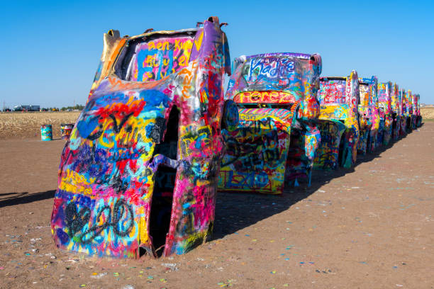 Cadillac Ranch 1 Cadillac Ranch, an iconic stop on Route 66, is an art installation and a  popular landmark. It was created in 1974. Ten Cadillacs are partially buried nose down in the ground. Visitors spray paint their random art and graffiti, resulting in a constantly evolving artistic expression
Amarillo, TX
05/09/2022 robertmichaud stock pictures, royalty-free photos & images