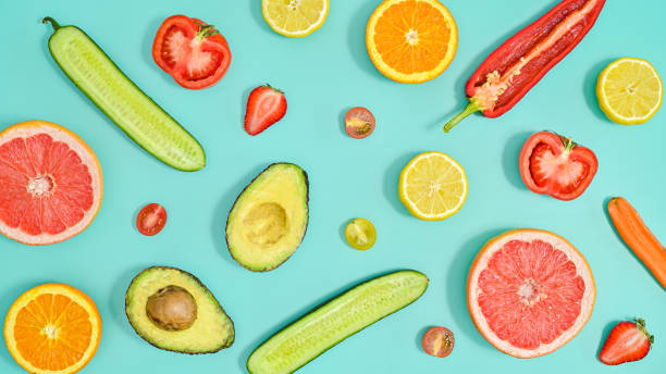 Summer healthy organic fruits and vegetables pattern on pastel blue background. Flat lay.