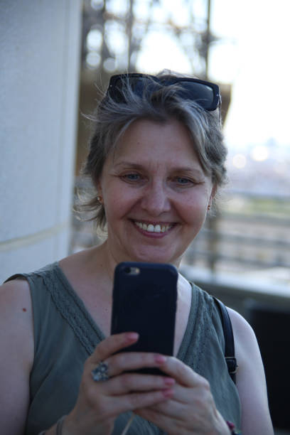 istock Pretty middle aged woman taking picture 1415243748