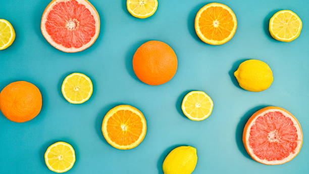istock Summer creative oranges, lemons and grapefruits pattern on bluebackground. Tropic citrus fruits concept. Flat lay 1415243818