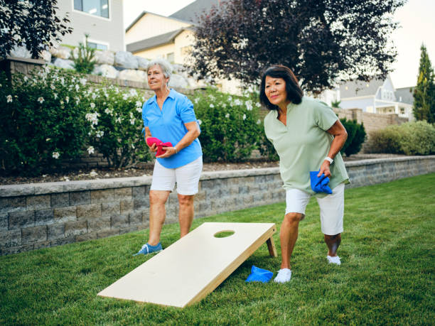 istock Backyard Party Playing Cornhole Bean Bag Toss Game 1415243997