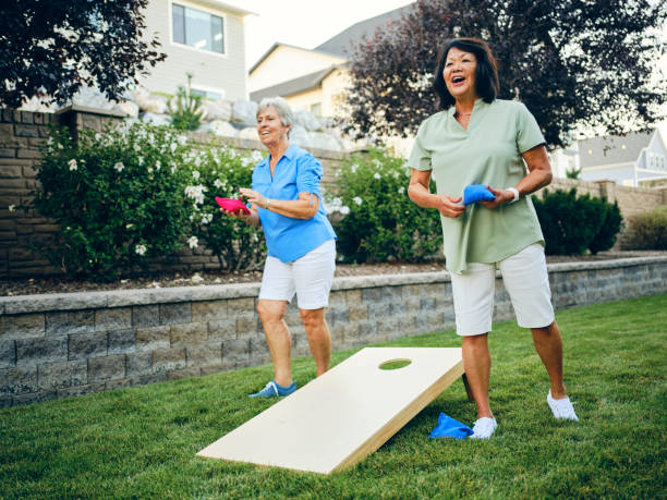 istock Backyard Party Playing Cornhole Bean Bag Toss Game 1415244027