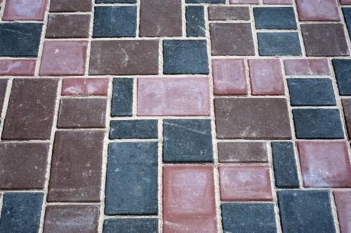 Paving slabs of different colors and shapes.Texture of different colored patterned paving slabs .