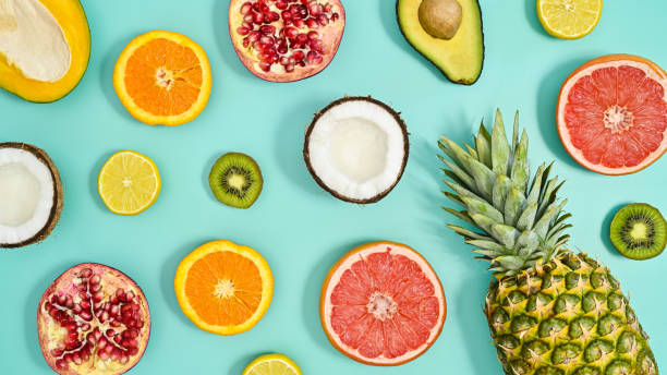 istock Summer tropic pattern made with exotic fruits on pastel tirquoise background. Flat lay. 1415245290