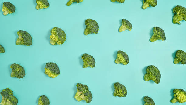 istock Broccoli creative pattern on pastel cyan background. Healthy food vegetables concept. Flat lay 1415245610