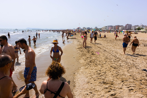 Beach with bathers in summer. Rimini, Italy, editorial image. High quality photo