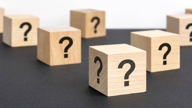 istock front view on many wood cubes with question marks. many question arising concept 1415247900
