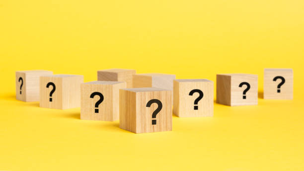 istock front view on many wood cubes with question marks. many question arising concept, yellow background 1415247988