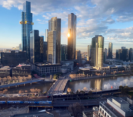 Melbourne with early morning light and a train