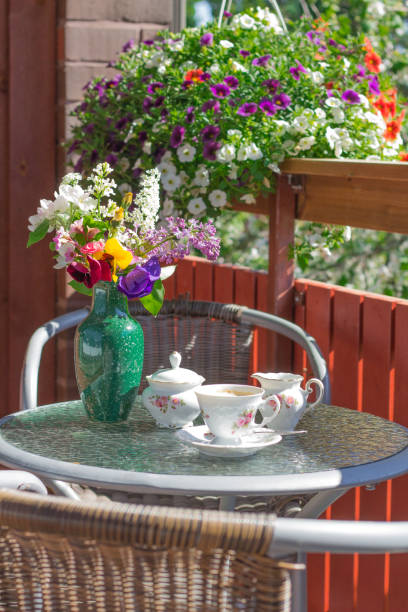 istock cofee set on the  cofee litle table in the banch in summer sunny day 1415250170