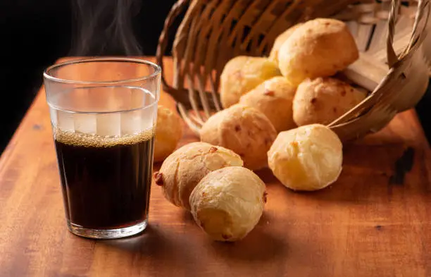 Cheese bread, beautiful cheese breads on rustic wood and a cup of hot coffee. selective focus.